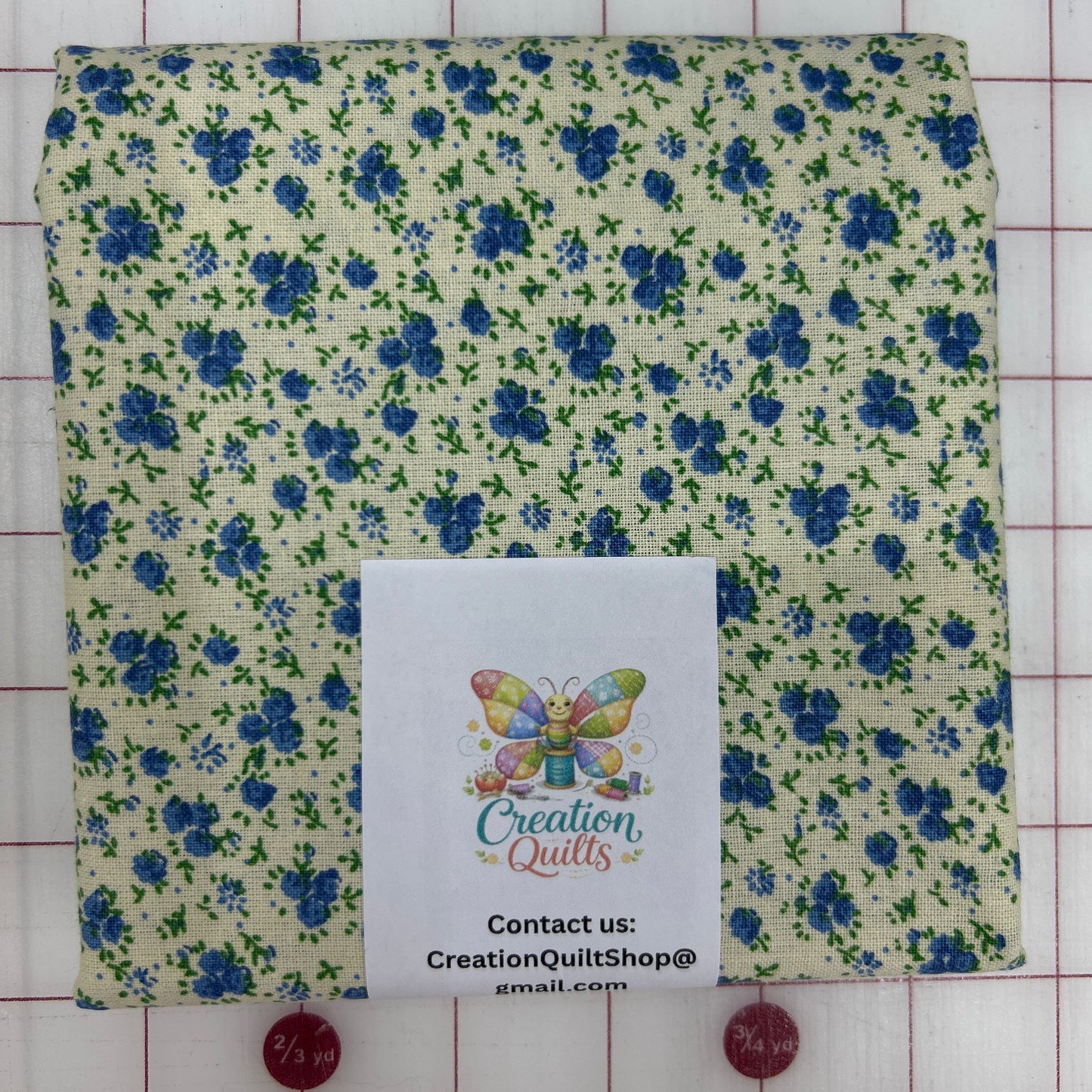 Cream with small blue flowers